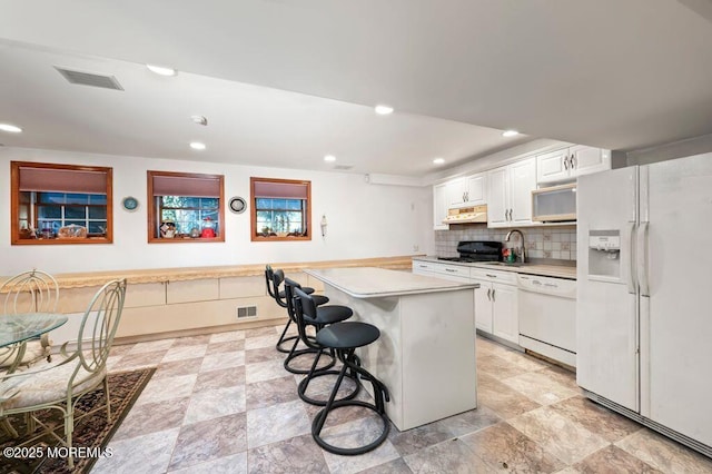 8 Tiberon Dr, Holmdel, NJ 07733 - kitchen with a sink, white cabinets, visible vents, white appliances, and light countertops