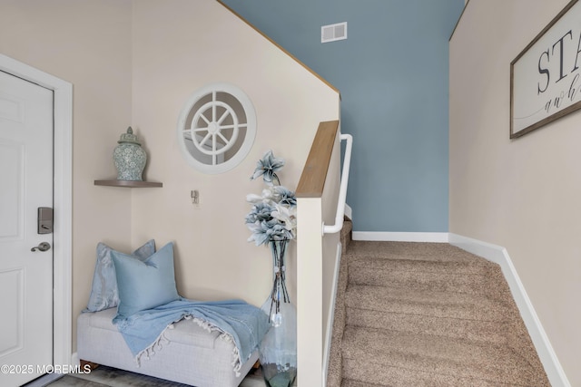 staircase featuring baseboards, carpet, and visible vents