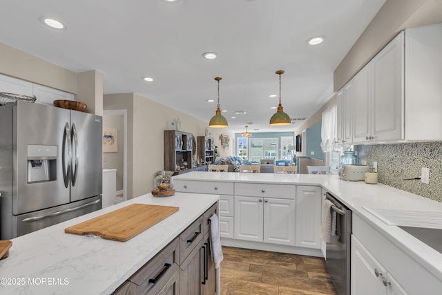 kitchen featuring hanging light fixtures, appliances with stainless steel finishes, white cabinets, and recessed lighting