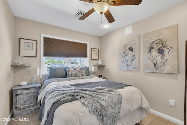 carpeted bedroom with baseboards, a ceiling fan, and visible vents