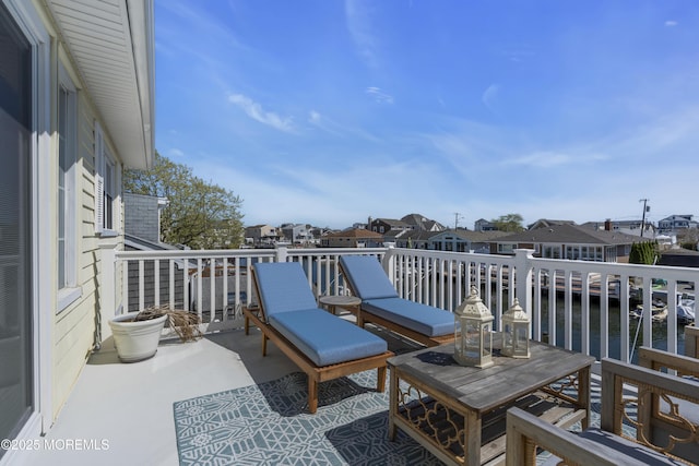 balcony with a water view and a residential view