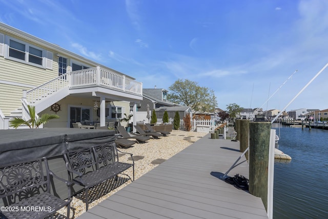 view of dock with a residential view and a water view