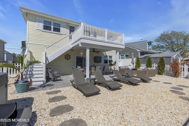 rear view of house with stairs, ceiling fan, fence, and a patio