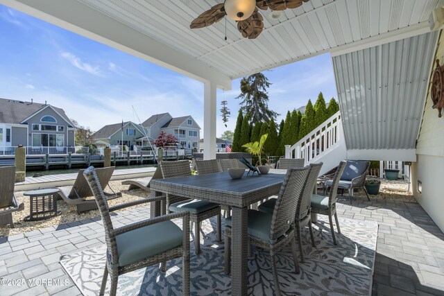 view of patio / terrace with a residential view, a ceiling fan, and outdoor dining space