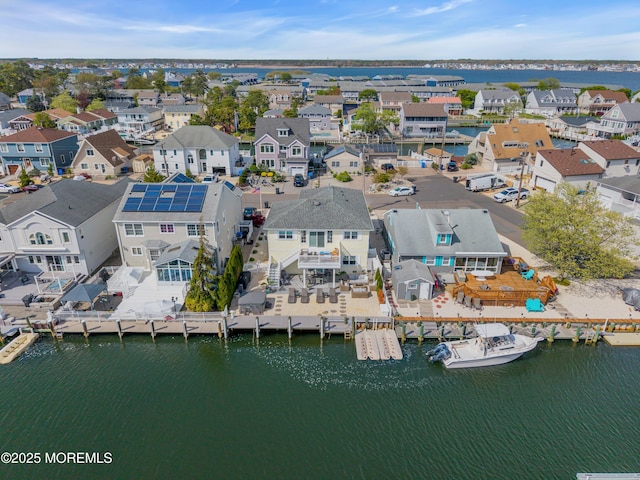 bird's eye view with a residential view and a water view