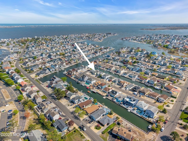 birds eye view of property with a water view and a residential view