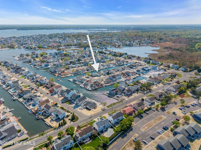 birds eye view of property featuring a residential view and a water view