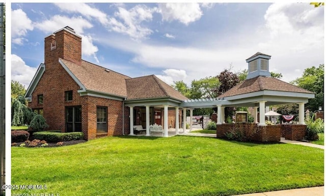 97 Gimbel Pl Unit 1903, Ocean Twp, NJ 07712 - back of house featuring brick siding, a lawn, roof with shingles, a chimney, and a gazebo