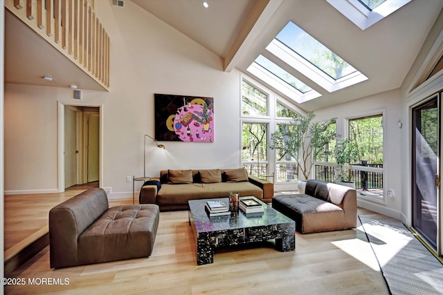 15 Evan Dr, Morganville, NJ 07751 - living area with a skylight, high vaulted ceiling, wood finished floors, and baseboards