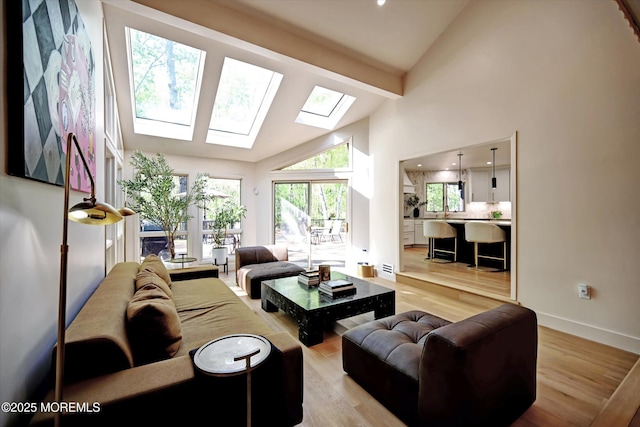 15 Evan Dr, Morganville, NJ 07751 - living room with a skylight, light wood-style floors, beam ceiling, high vaulted ceiling, and baseboards