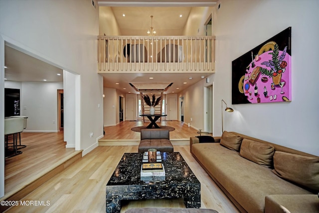 15 Evan Dr, Morganville, NJ 07751 - living room featuring a high ceiling, wood finished floors, a chandelier, and baseboards