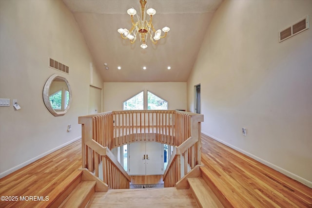 15 Evan Dr, Morganville, NJ 07751 - stairway featuring a chandelier, high vaulted ceiling, wood finished floors, and baseboards
