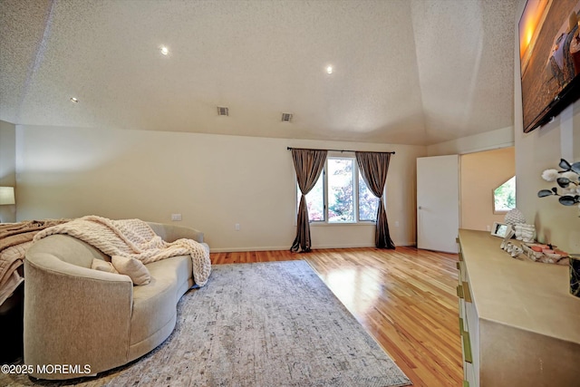 15 Evan Dr, Morganville, NJ 07751 - living room with a textured ceiling, healthy amount of natural light, light wood finished floors, vaulted ceiling, and baseboards