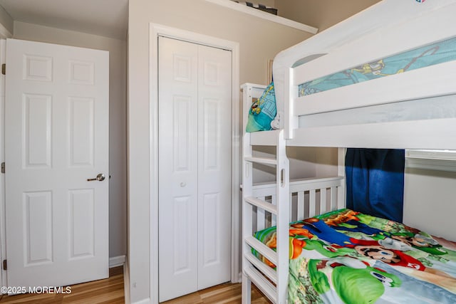 bedroom with a closet and wood finished floors