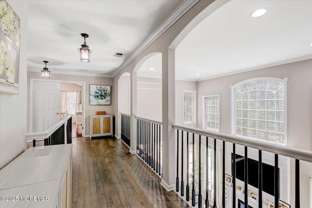 hallway with crown molding, dark wood-style flooring, arched walkways, recessed lighting, and visible vents