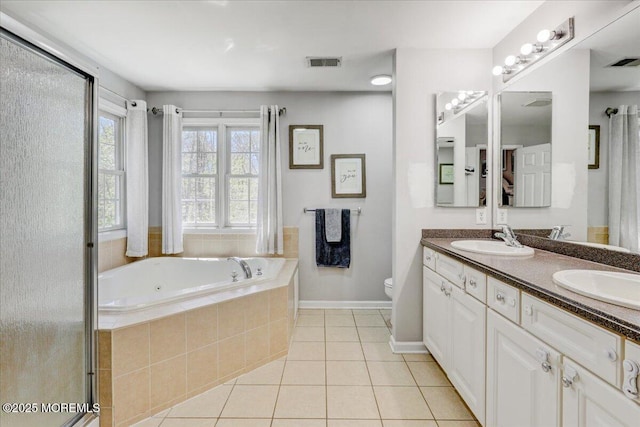 bathroom featuring a sink, tile patterned floors, a garden tub, and visible vents