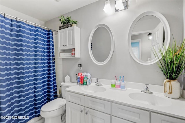 full bathroom with double vanity, a sink, a shower with shower curtain, and toilet