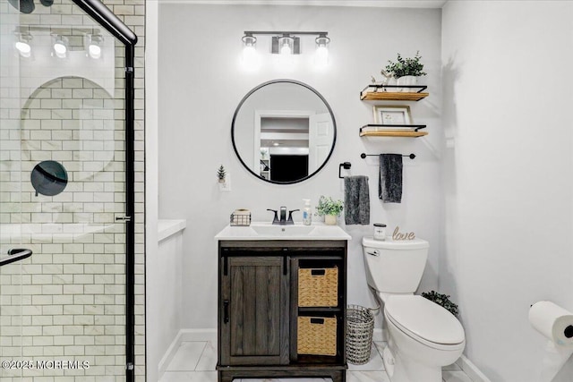 bathroom with vanity, baseboards, toilet, and a shower stall