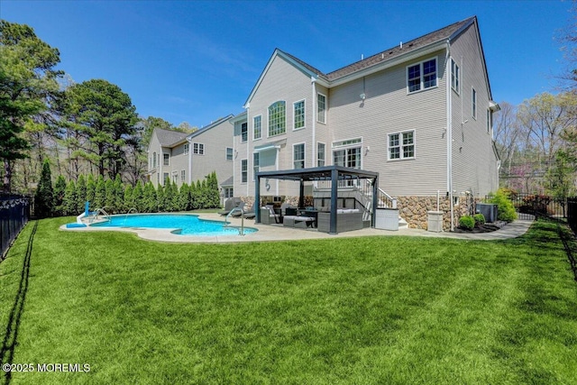 rear view of house featuring an outdoor hangout area, fence, a yard, and a patio area