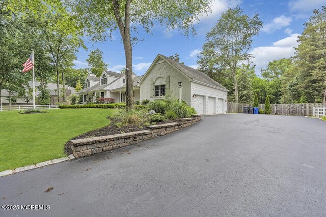 1570 Beaver Hollow Dr, Toms River, NJ 08755 - view of front of home featuring a garage, a front lawn, fence, and driveway
