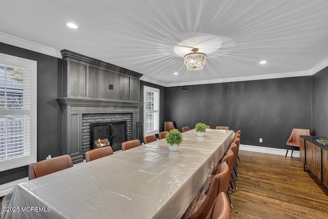 1570 Beaver Hollow Dr, Toms River, NJ 08755 - dining room featuring crown molding, dark wood-style flooring, a brick fireplace, recessed lighting, and baseboards