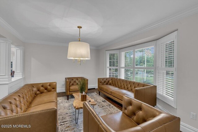 1570 Beaver Hollow Dr, Toms River, NJ 08755 - living area featuring crown molding, an inviting chandelier, decorative columns, wood finished floors, and baseboards