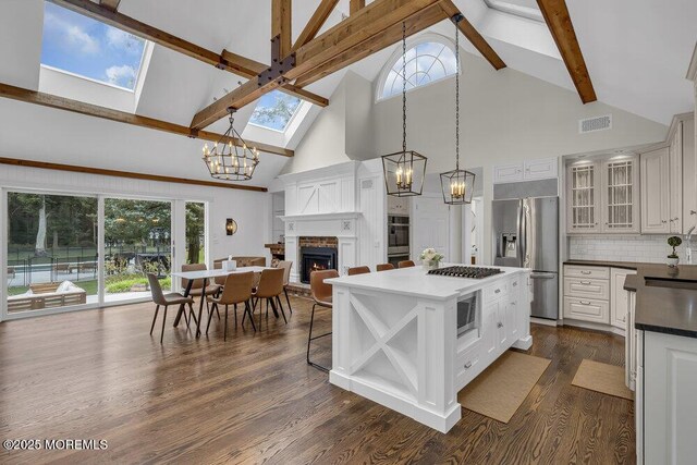 1570 Beaver Hollow Dr, Toms River, NJ 08755 - kitchen featuring visible vents, high vaulted ceiling, a notable chandelier, a skylight, and stainless steel appliances