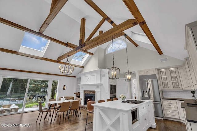1570 Beaver Hollow Dr, Toms River, NJ 08755 - kitchen featuring visible vents, a skylight, high vaulted ceiling, a chandelier, and stainless steel appliances