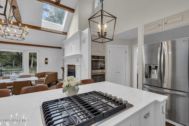 1570 Beaver Hollow Dr, Toms River, NJ 08755 - kitchen with open floor plan, appliances with stainless steel finishes, a notable chandelier, and high vaulted ceiling