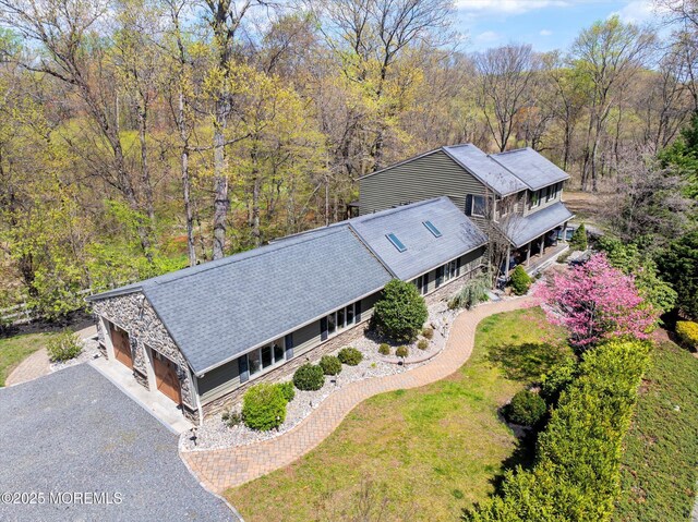 drone / aerial view with a wooded view