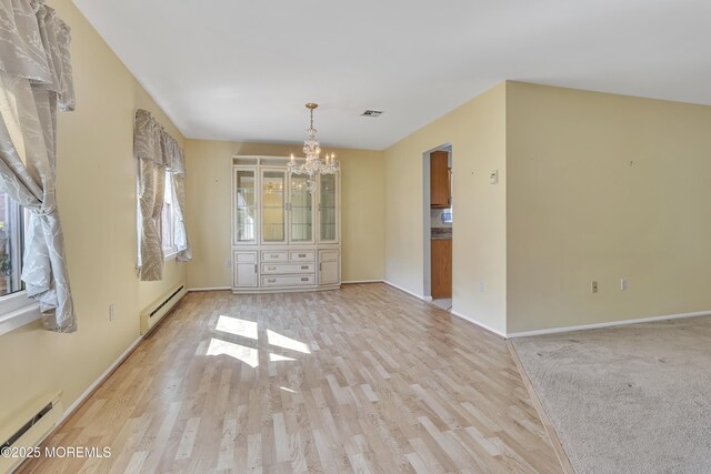 3 Tudor Ct, Brick, NJ 08723 - empty room featuring baseboards, a notable chandelier, baseboard heating, and light wood finished floors