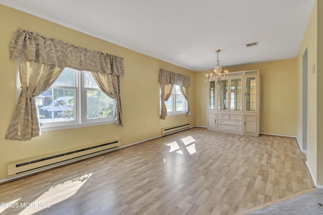3 Tudor Ct, Brick, NJ 08723 - unfurnished dining area with a chandelier, plenty of natural light, and a baseboard radiator
