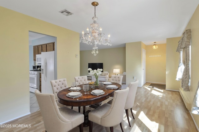 3 Tudor Ct, Brick, NJ 08723 - dining area featuring visible vents, light wood-style floors, baseboards, a chandelier, and a baseboard radiator
