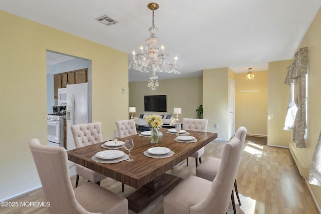 3 Tudor Ct, Brick, NJ 08723 - dining space with a notable chandelier, light wood finished floors, a baseboard heating unit, and visible vents