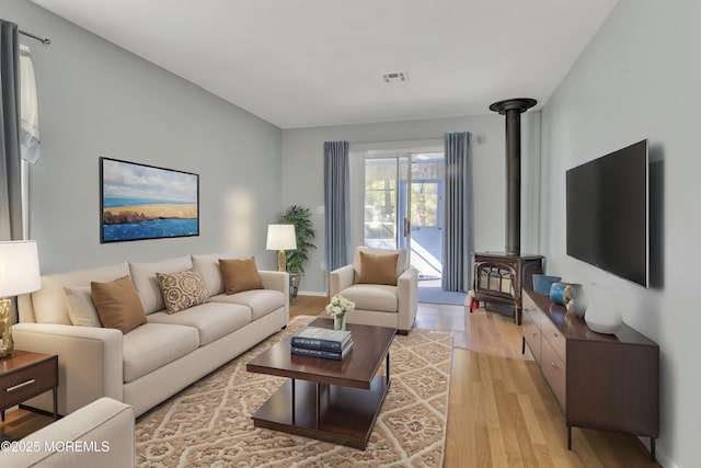 3 Tudor Ct, Brick, NJ 08723 - living room featuring a wood stove, light wood finished floors, and visible vents