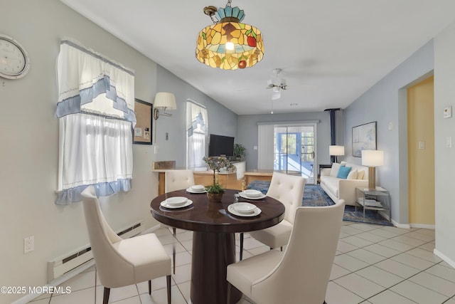 3 Tudor Ct, Brick, NJ 08723 - dining area with a wood stove, baseboards, ceiling fan, a baseboard heating unit, and light tile patterned floors