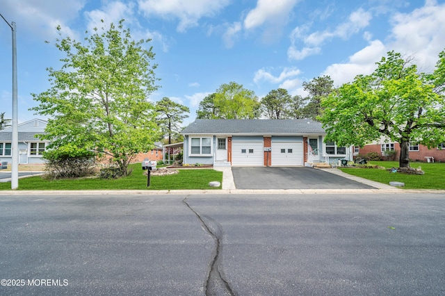 view of front of home with a garage, asphalt driveway, and a front lawn