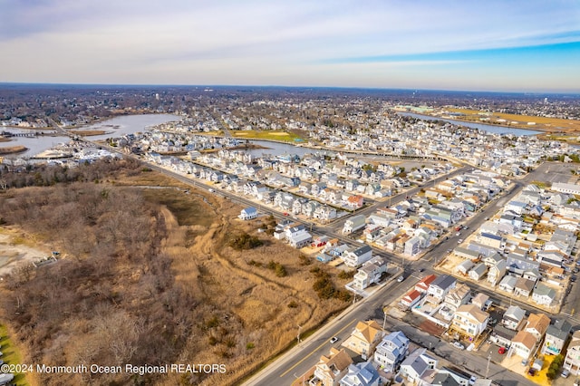 drone / aerial view featuring a water view and a residential view