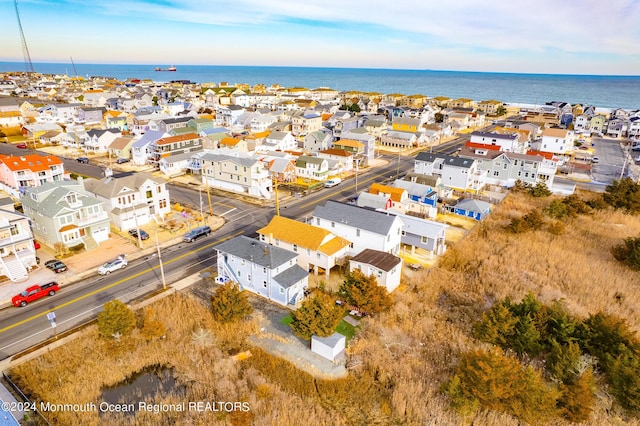 drone / aerial view featuring a water view and a residential view