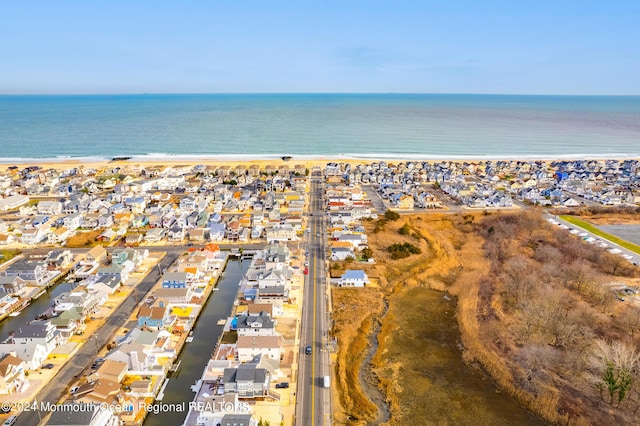 birds eye view of property with a beach view, a residential view, and a water view
