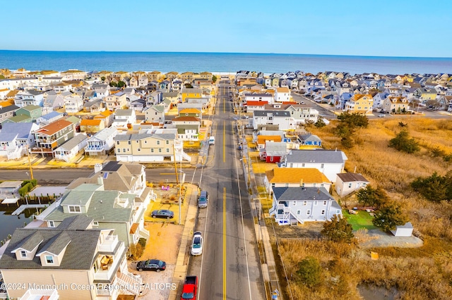 drone / aerial view featuring a residential view and a water view