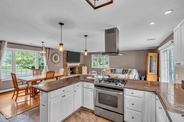 kitchen featuring gas stove, island range hood, healthy amount of natural light, open floor plan, and recessed lighting