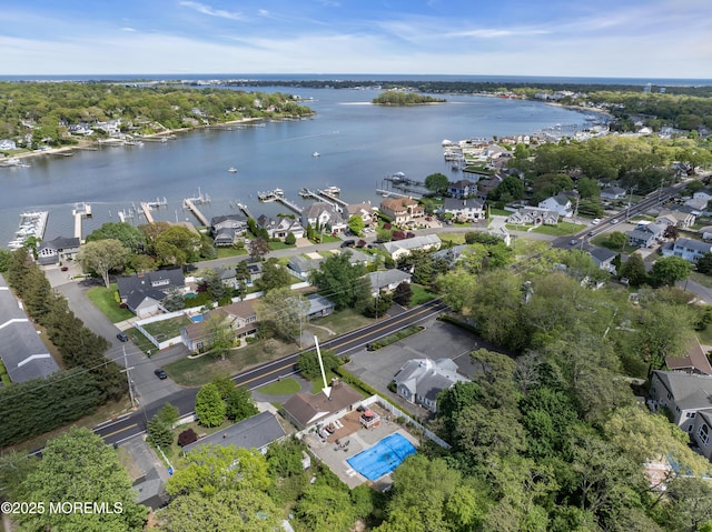 aerial view of property and surrounding area with a nearby body of water and nearby suburban area