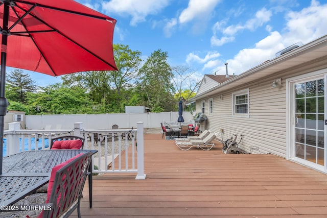 wooden terrace featuring outdoor dining area