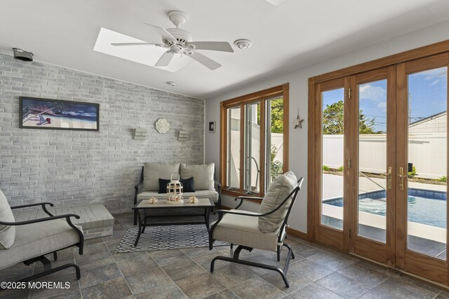 sunroom featuring a skylight and french doors