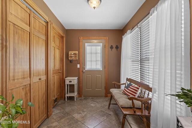 doorway to outside featuring stone finish floor