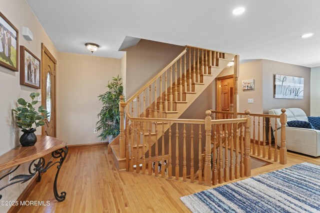 stairs with wood-type flooring, recessed lighting, and baseboards