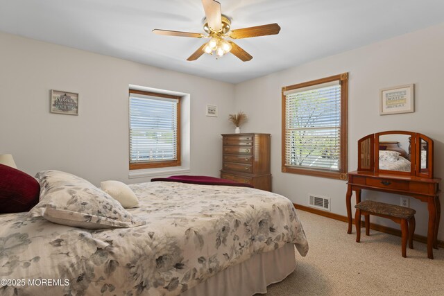 bedroom featuring visible vents, a ceiling fan, carpet, and baseboards