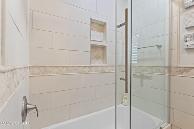 full bath featuring enclosed tub / shower combo and tile walls