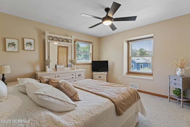 bedroom featuring baseboards, light carpet, a ceiling fan, and visible vents